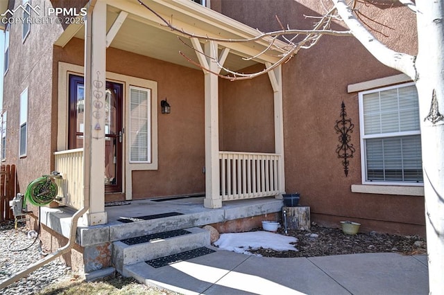 property entrance featuring stucco siding