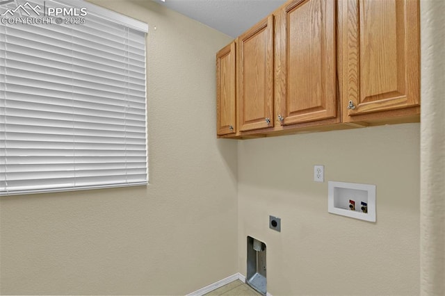 clothes washing area featuring baseboards, hookup for a washing machine, cabinet space, and hookup for an electric dryer