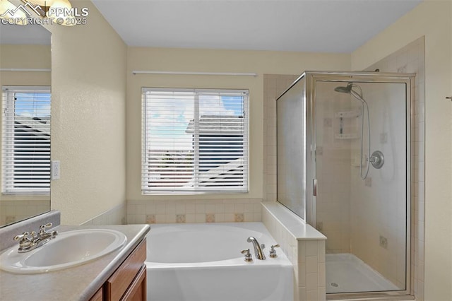 bathroom with a garden tub, a shower stall, and vanity