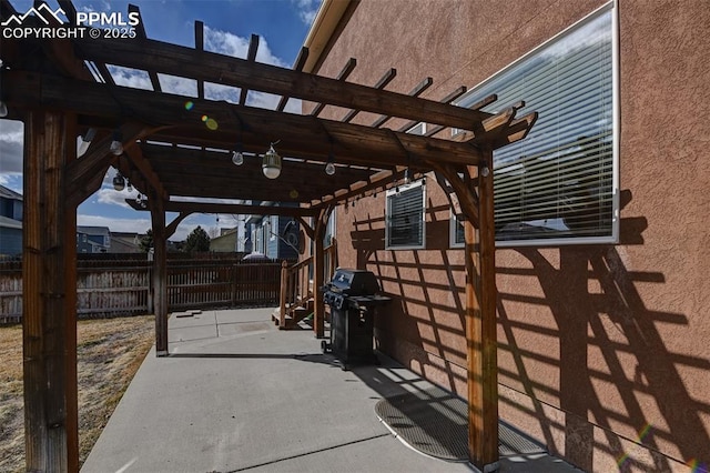 view of patio with fence, area for grilling, and a pergola