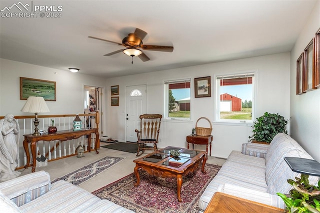 living area featuring carpet flooring and a ceiling fan