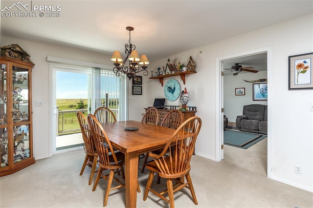 dining area with light carpet, baseboards, and a notable chandelier