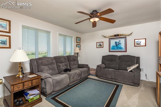 carpeted living room with ceiling fan