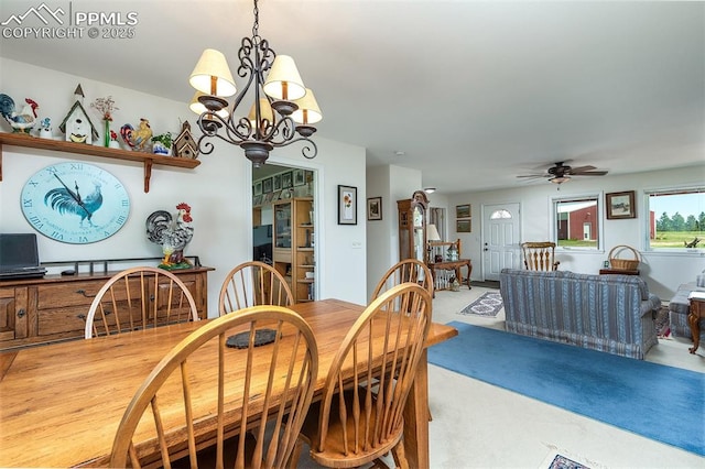 dining room with light colored carpet and ceiling fan with notable chandelier