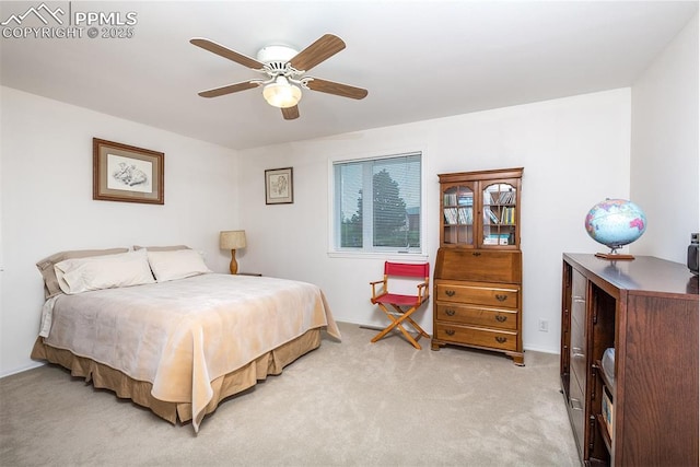 bedroom featuring baseboards, a ceiling fan, and light colored carpet