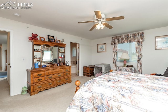 bedroom with a ceiling fan and light carpet