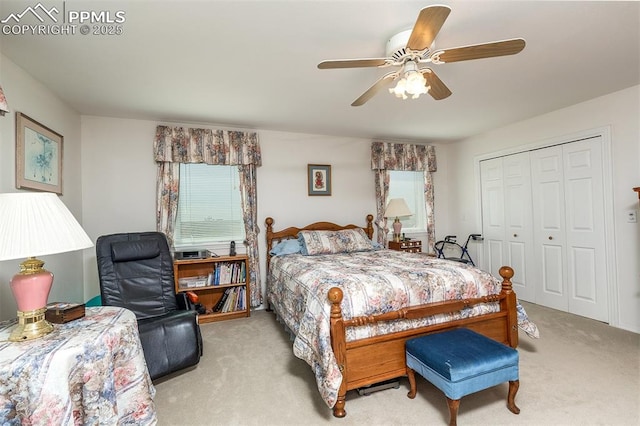 bedroom with light carpet, ceiling fan, multiple windows, and a closet