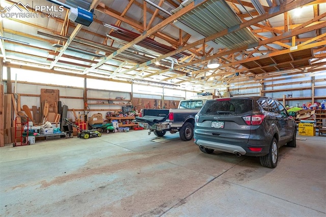 garage featuring a garage door opener and metal wall