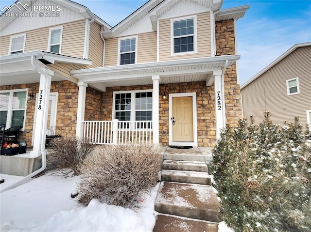 view of front of house with covered porch and stone siding