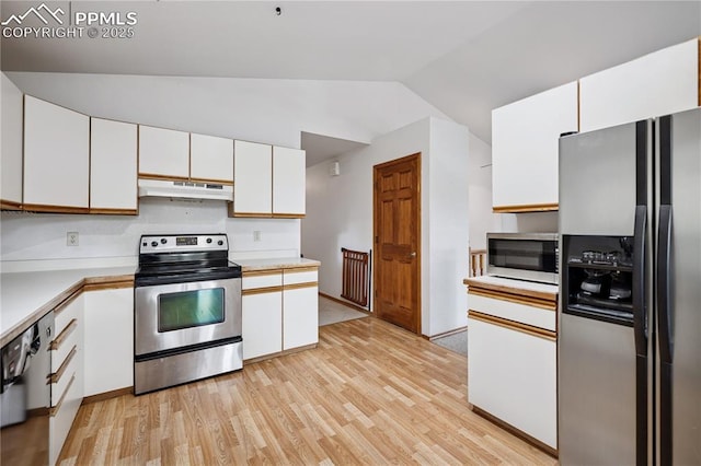 kitchen featuring light countertops, appliances with stainless steel finishes, white cabinetry, vaulted ceiling, and under cabinet range hood