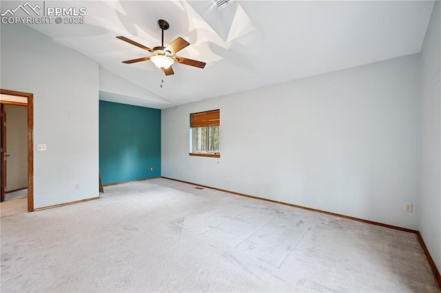 carpeted spare room featuring ceiling fan, baseboards, and vaulted ceiling