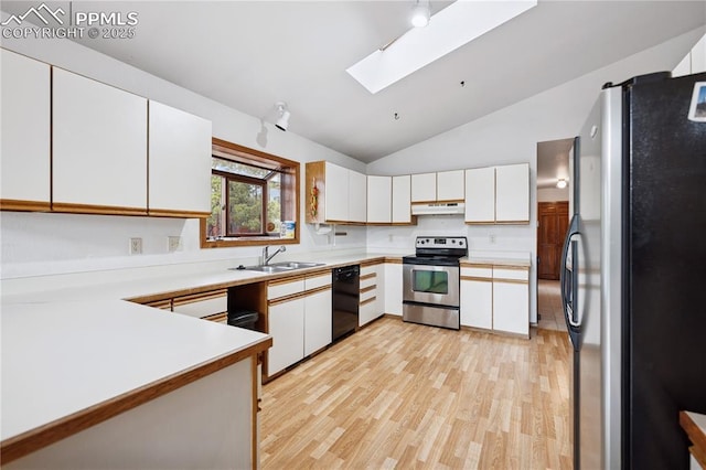 kitchen with appliances with stainless steel finishes, light countertops, under cabinet range hood, white cabinetry, and a sink