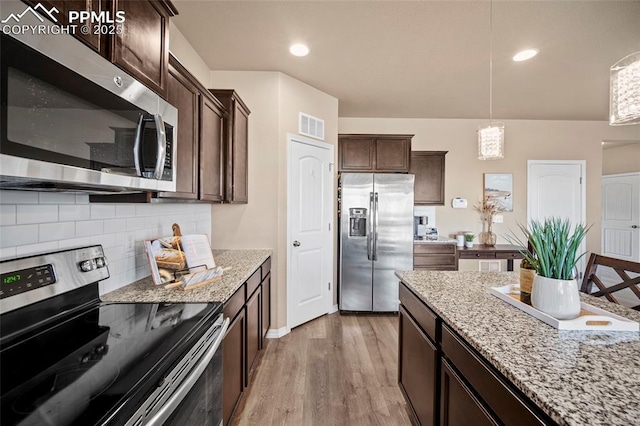 kitchen with tasteful backsplash, visible vents, dark brown cabinets, light wood-type flooring, and appliances with stainless steel finishes