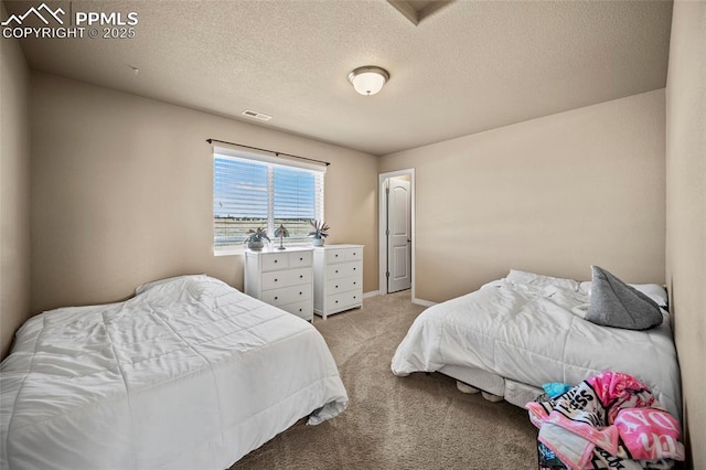 bedroom with light colored carpet, visible vents, and a textured ceiling