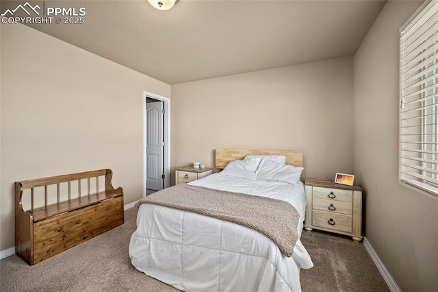 carpeted bedroom featuring baseboards