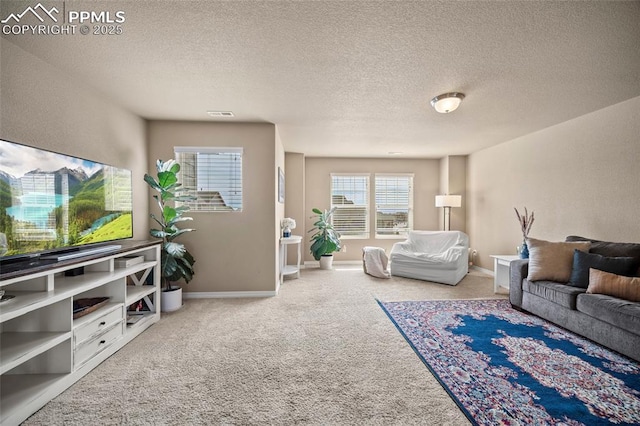 carpeted living room with visible vents, a textured ceiling, and baseboards