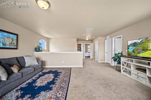 carpeted living room featuring visible vents, baseboards, and a textured ceiling