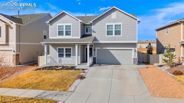 view of front of house featuring fence, driveway, a porch, an attached garage, and stone siding