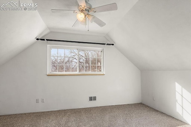 additional living space with carpet floors, lofted ceiling, visible vents, and ceiling fan