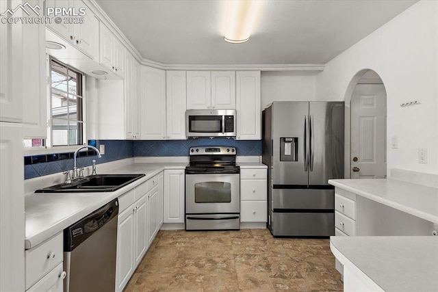 kitchen featuring white cabinetry, appliances with stainless steel finishes, light countertops, and a sink