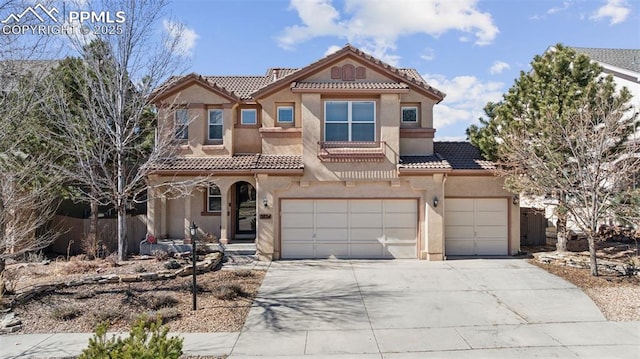 mediterranean / spanish-style home featuring driveway, stucco siding, a garage, and a tiled roof