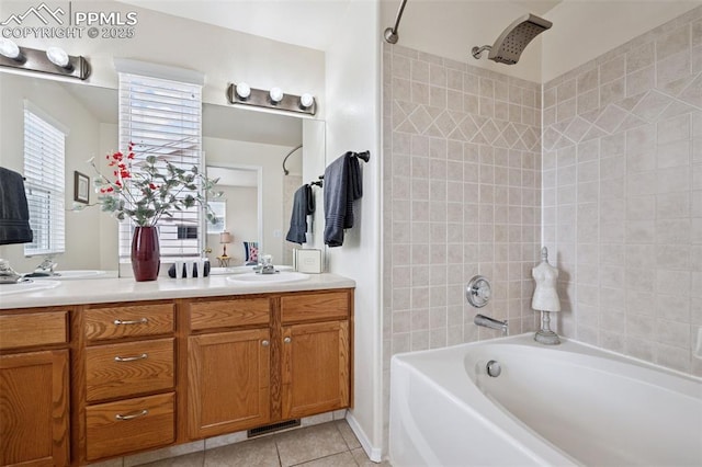 full bath with double vanity, visible vents, tile patterned floors, washtub / shower combination, and a sink