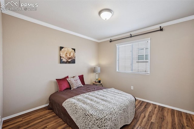 bedroom featuring ornamental molding, wood finished floors, and baseboards