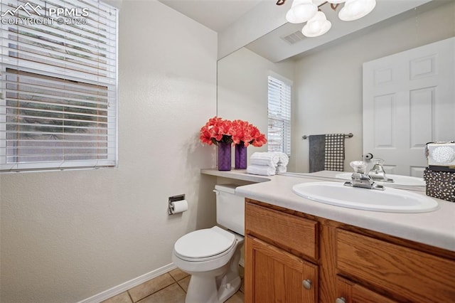 bathroom with visible vents, toilet, vanity, baseboards, and tile patterned floors