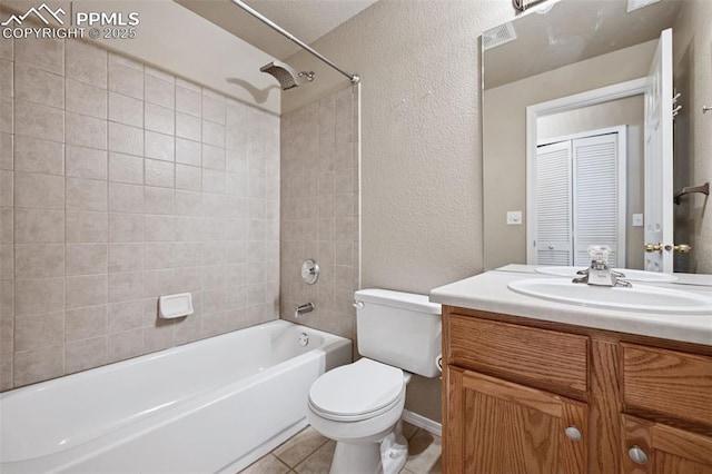 full bathroom featuring a textured wall, toilet, tile patterned flooring, vanity, and shower / washtub combination