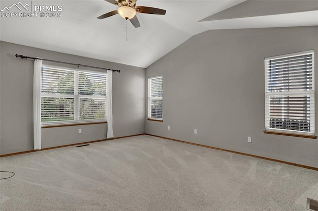 empty room with vaulted ceiling, ceiling fan, carpet, and baseboards