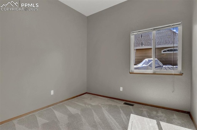 empty room with light carpet, visible vents, and baseboards