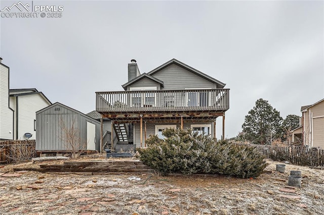 view of front of home with stairs, a chimney, fence, and a wooden deck