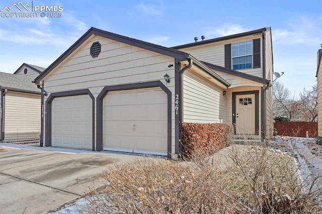 view of front of property with a garage and concrete driveway