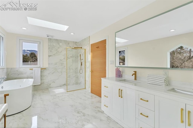 full bath featuring double vanity, a marble finish shower, marble finish floor, a freestanding bath, and a sink