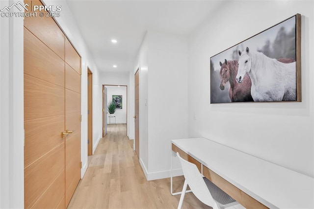 hall with light wood-type flooring, baseboards, and recessed lighting