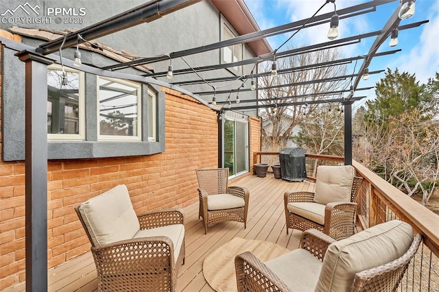 wooden terrace featuring grilling area and a pergola