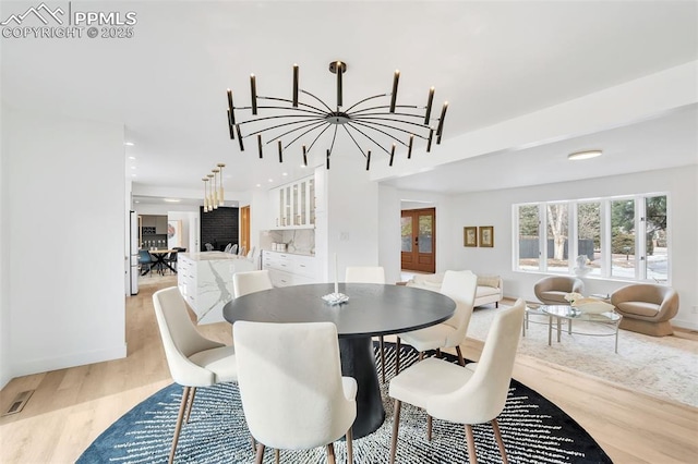 dining space with light wood-style floors, baseboards, french doors, and recessed lighting