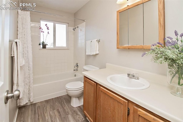 full bath featuring toilet, shower / bath combo, wood finished floors, and vanity