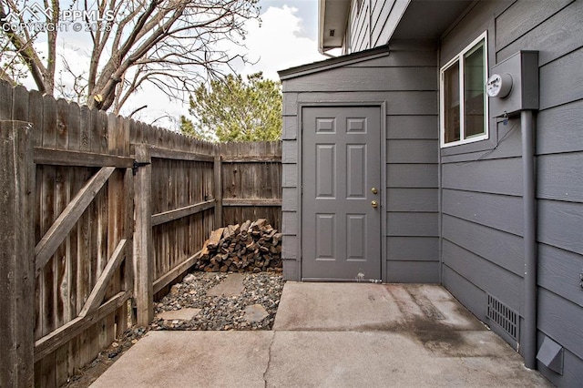 doorway to property with a patio area and fence