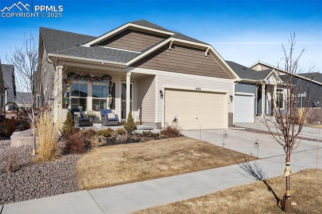 view of front of property with driveway, covered porch, an attached garage, and roof with shingles