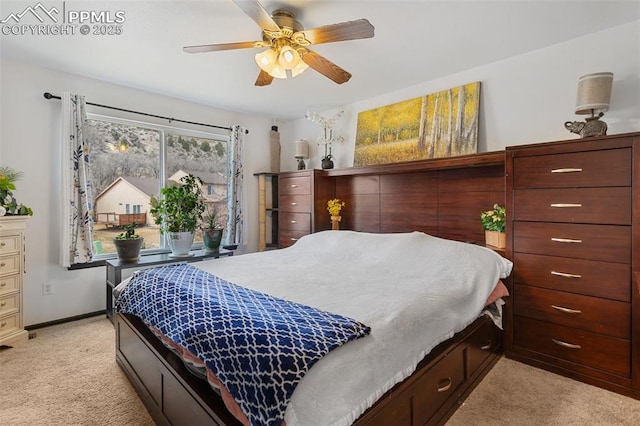 bedroom featuring baseboards, ceiling fan, and light colored carpet