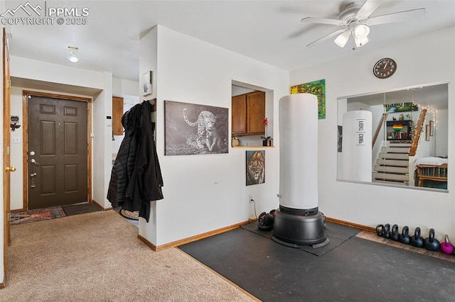 interior space featuring carpet floors, ceiling fan, and baseboards