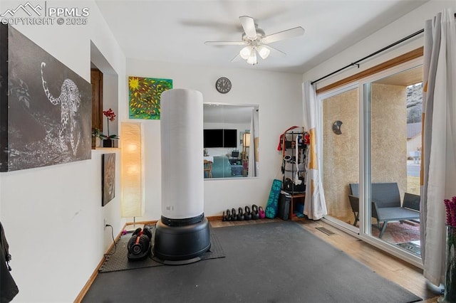 exercise room featuring wood finished floors and a ceiling fan