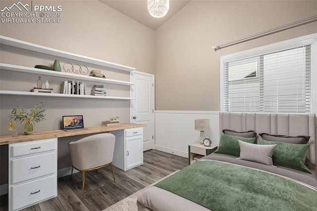 bedroom with lofted ceiling, wainscoting, dark wood finished floors, and built in study area