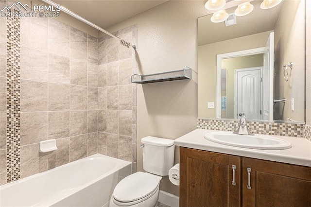 bathroom featuring toilet, visible vents, vanity, shower / bathing tub combination, and tasteful backsplash