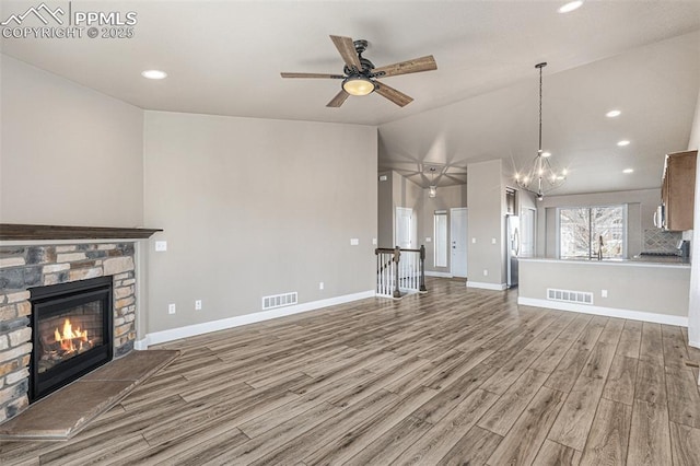 unfurnished living room with light wood-style flooring, a fireplace, visible vents, and baseboards