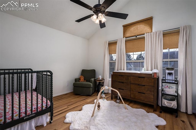 bedroom featuring lofted ceiling, ceiling fan, baseboards, and wood finished floors