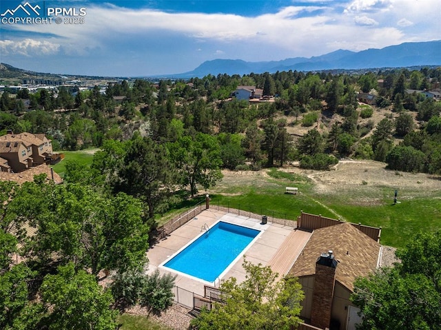 view of pool featuring an enclosed area and a mountain view