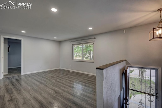 empty room featuring dark wood-style floors, recessed lighting, and baseboards