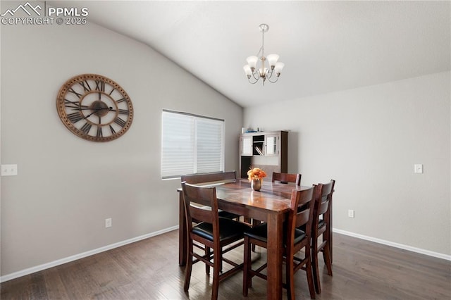 dining space with dark wood-type flooring, lofted ceiling, baseboards, and an inviting chandelier